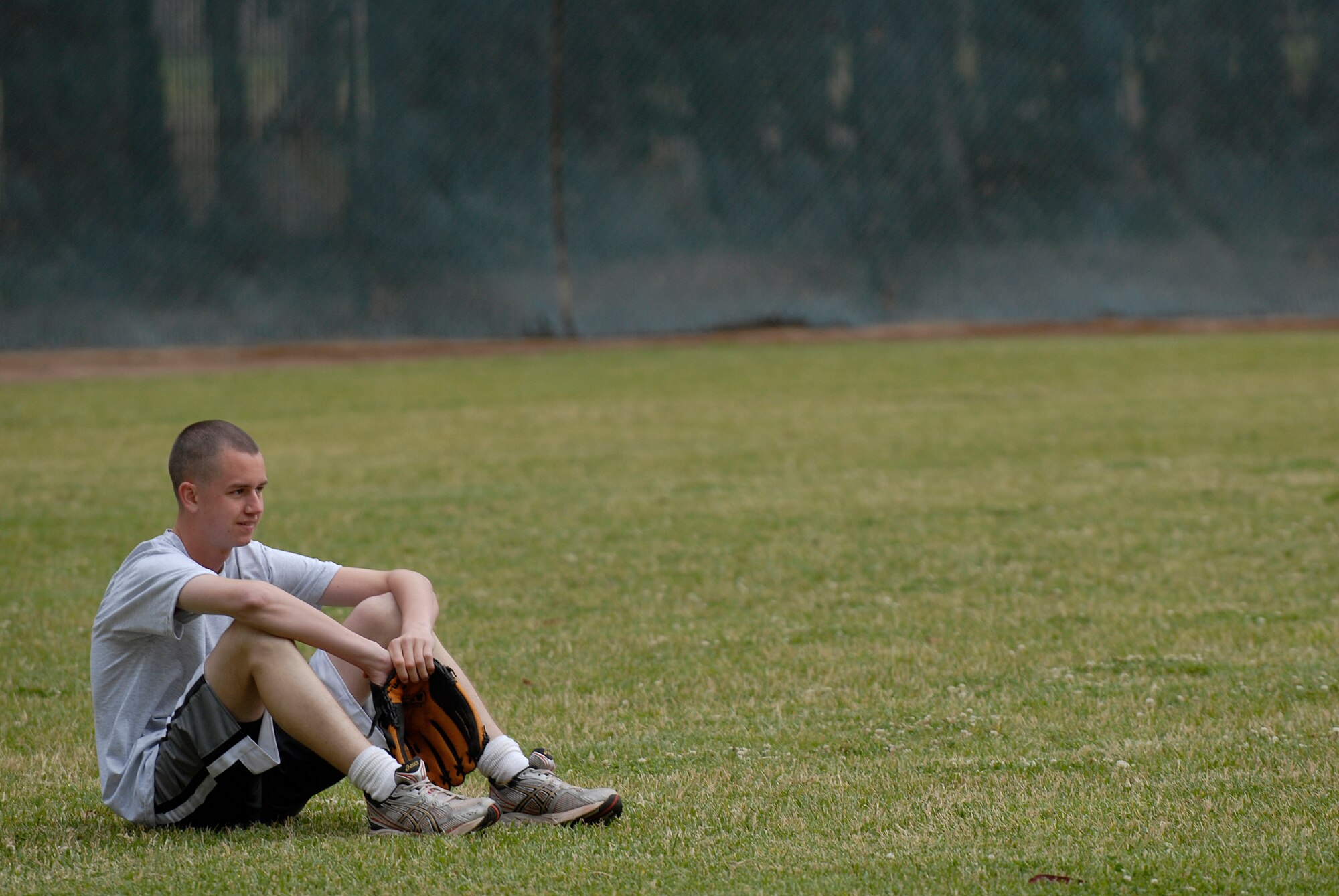 VANDENBERG AIR FORCE BASE, Calif. --  Liam O'Brien, a 381st Training Support Squadron team member, waits for the beginning of  the intramural softball game at the base field here Monday, June 7, 2010.  The  381st TRSS played against the 533rd Training Squadron team.  (U.S. Air Force photo/Senior Airman Andrew Satran) 

 