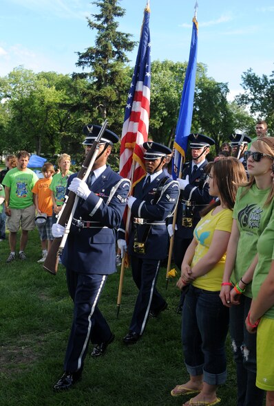 The Grand Forks Air Force Base Honor Guard marches in to present the colors during the opening ceremony for the American Cancer Society Relay for Life walk at University Park in Grand Forks, June 4. The Air Force Sergeants Association Chapter 964, Grand Forks Air Force Base, sponsored fundraising on base that raised more than $1,000 in support of cancer research. (U.S. Air Force photo by Staff Sgt. Suellyn Nuckolls) 