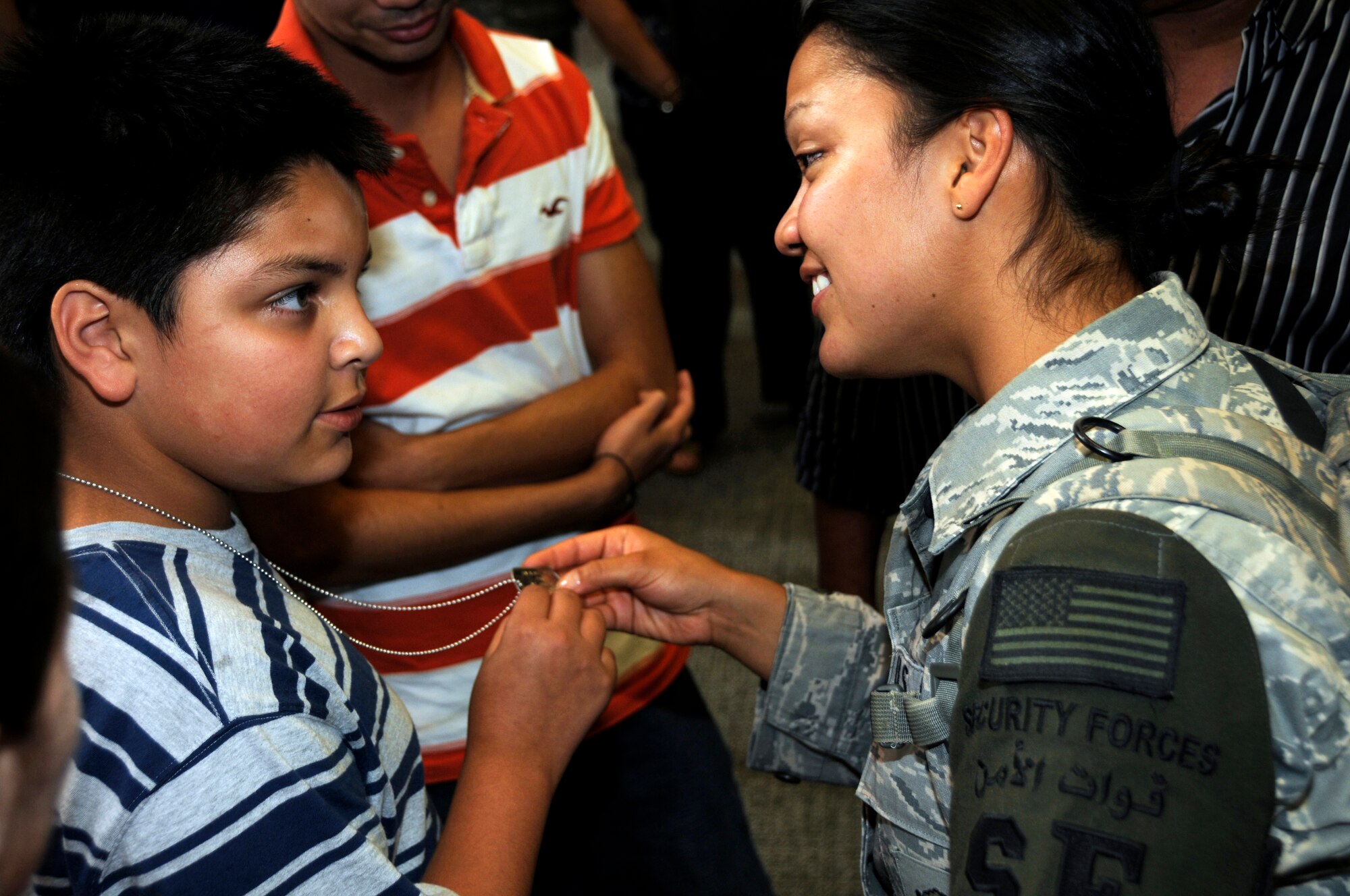 Airman 1st Class Alejandra Solis, 482nd Security Forces Squadron, shares a moment with her nephew  during a homecoming celebration at Miami International Airport on Monday, June 7.  Twenty-eight reservists from Homestead Air Reserve Base completed a six-month deployment to Iraq in which they provided security at Kirkuk Regional Air Base. (U.S. Air Force photo/Senior Airman Lou Burton)