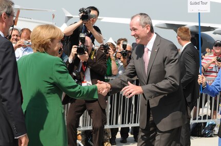 BERLIN -- Philip Murphy (right), U.S. Ambassador to the Federal Republic of Germany, greets Federal Republic of Germany Chancellor Angela Merkel during the unveiling of the ILA 2010 Berlin International Aerospace Exhibition and Conferences Air Show June 8 at Berlin-Schoenefeld Airport.  (U.S. Air Force photo/Staff Sgt. Julius Delos Reyes)