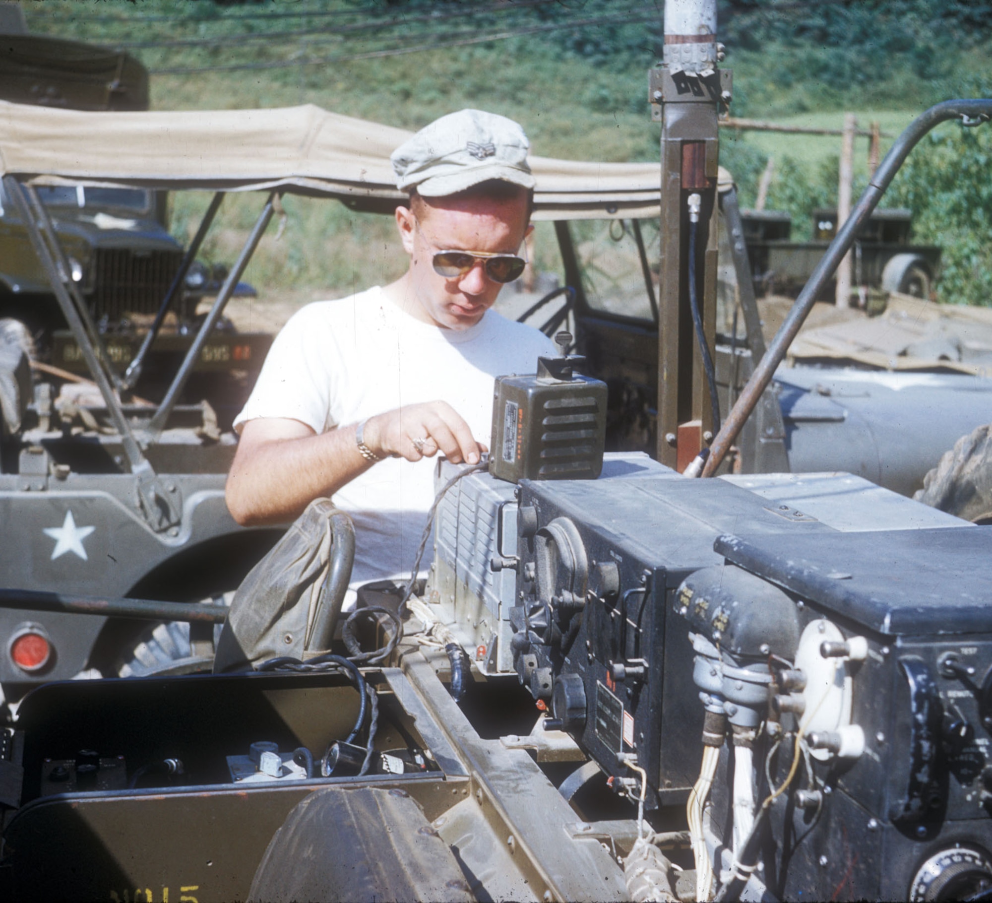 Driving over rough terrain battered the relatively fragile radios on TACP jeeps. They required constant maintenance, like that being done here by Airman 1st Class Rowland Straka. (U.S. Air Force photo)