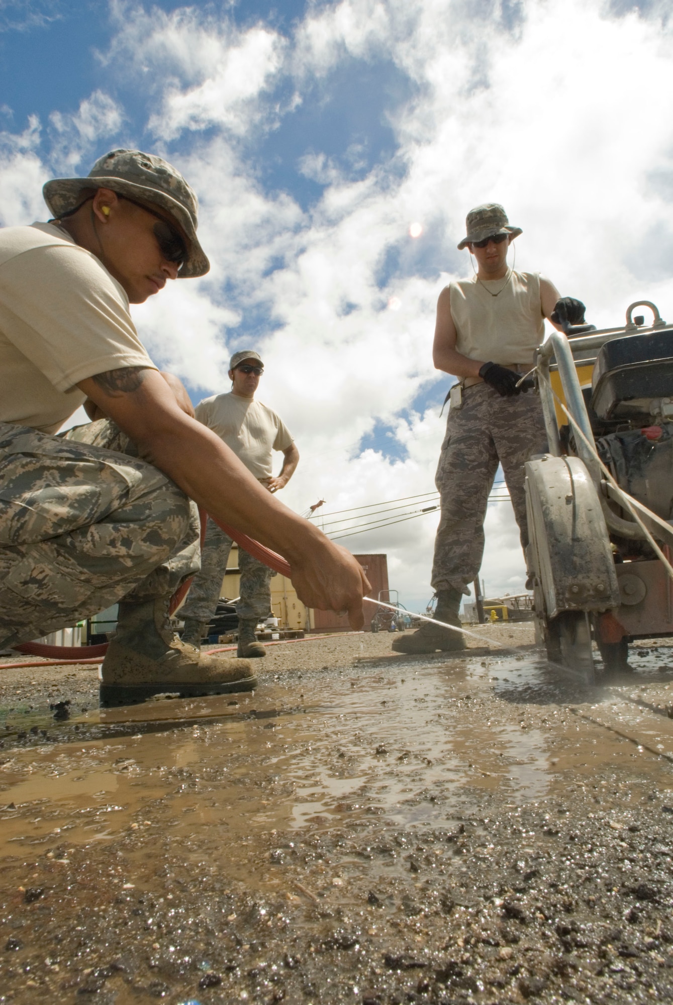 Airmen from the 146th Civil Engineering Squadron begin work together cutting the concrete on a construction site on Pearl City’s Naval base in Hawaii June 7, 2010. The Civil Engineering Squadron will be assisting with various construction projects over the course of two weeks including Barbers Point Coast Guard Base. (DoD photo by Airman 1st Class Nicholas Carzis, U.S. Air Force/Released)