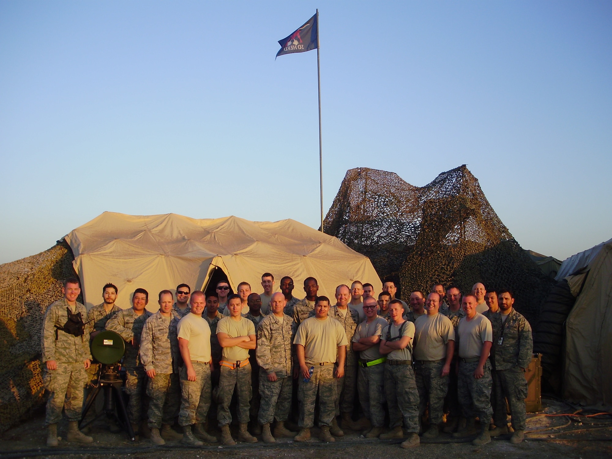 Members of the 32nd Combat Communications Squadron,34th CBCS and 3rd Combat Communications Support Squadron, Tinker Air Force Base, Okla. pose for a group photo early in their deployment to Haiti while the unit was at full strength. Members of the 3rd Combat Communications Group were supporting relief efforts in Haiti since February and the last remaining members returned home in June. (US Air Force photo)