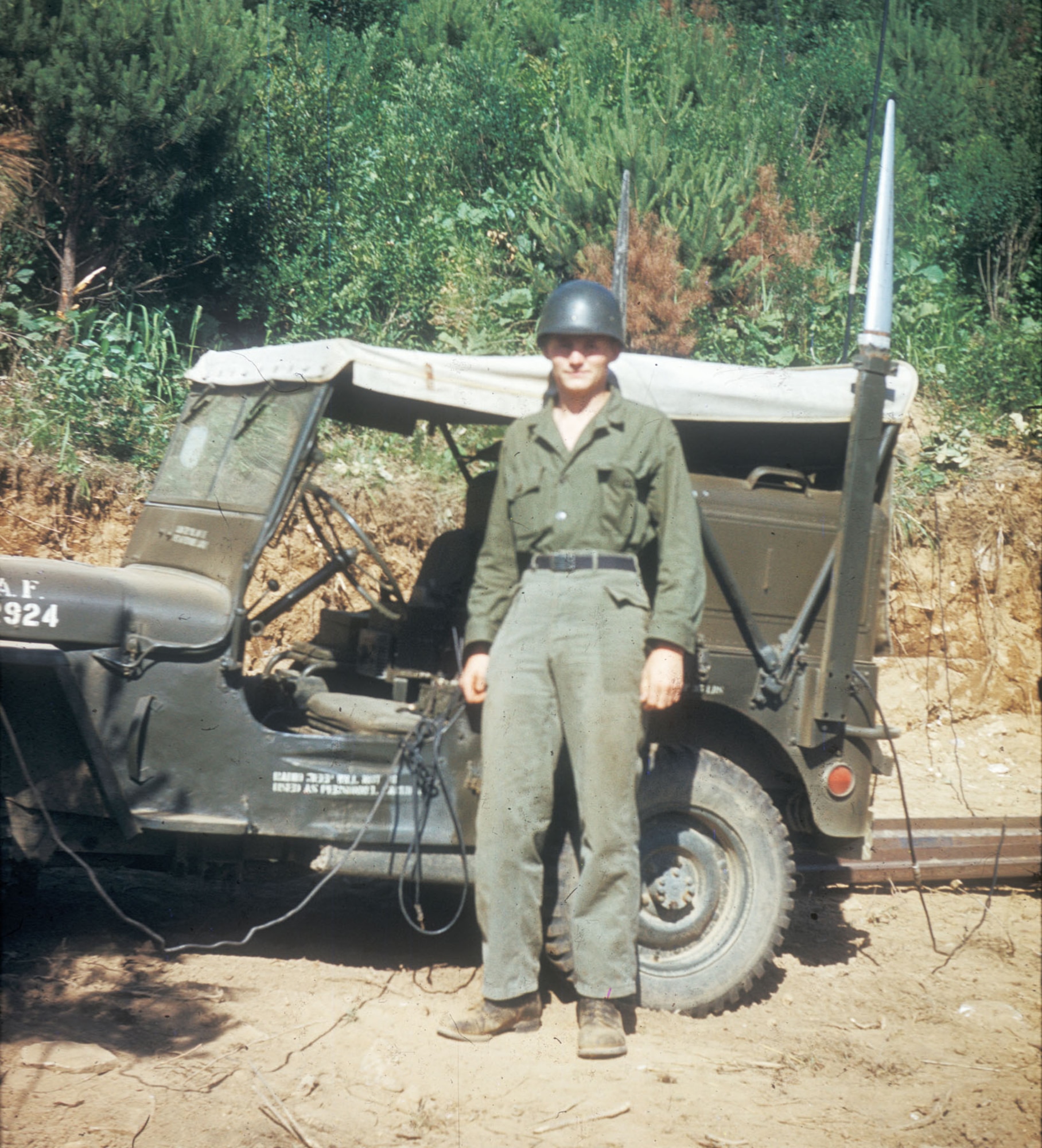 USAF Tactical Air Control Party (TACP) radioman with his jeep at the front lines in 1952. Air Force radio jeeps were easily identified by the large silver antennae protruding above the roof. (U.S. Air Force photo)