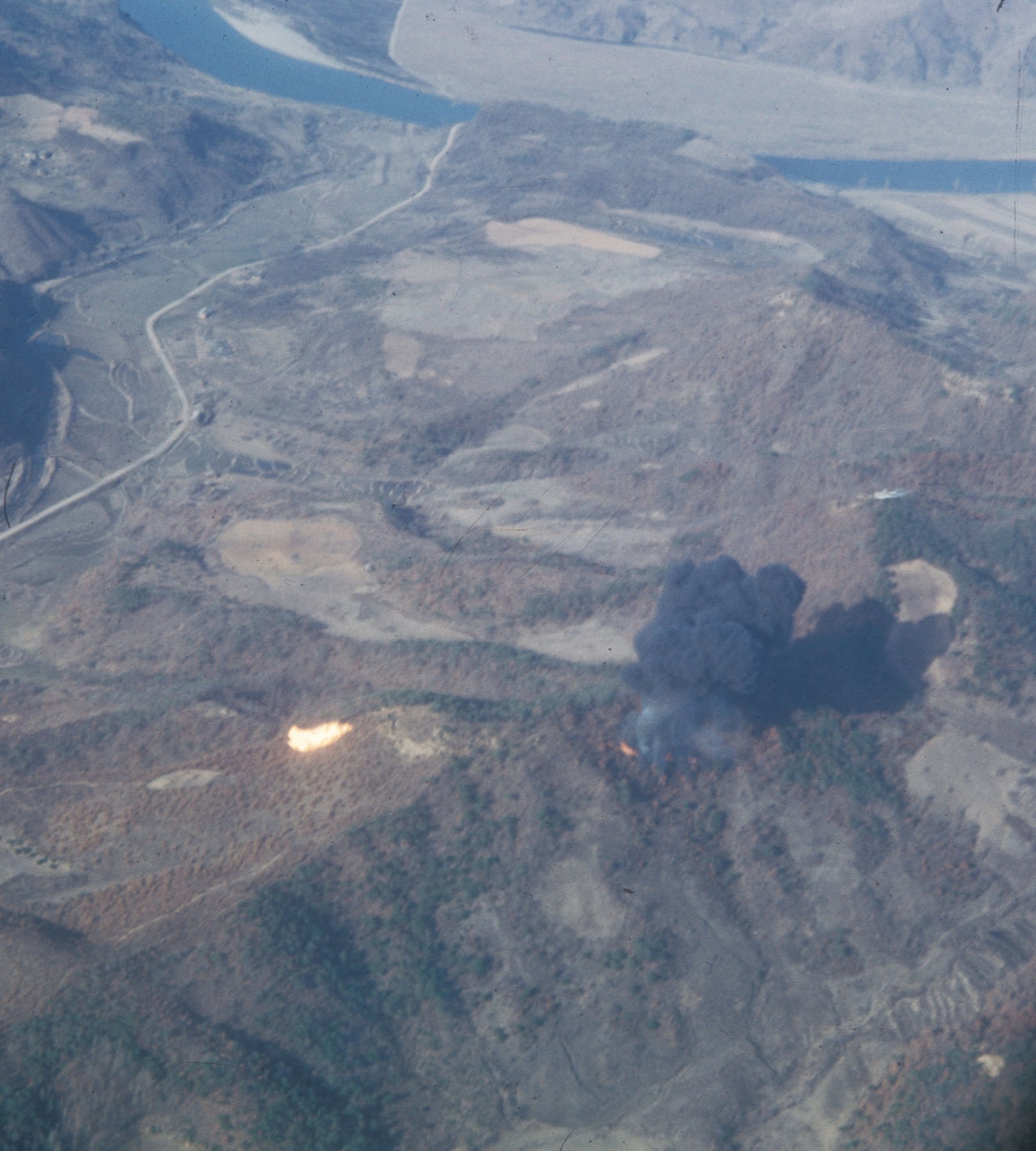 Mosquito-directed napalm strike on Communist positions. (U.S. Air Force photo)