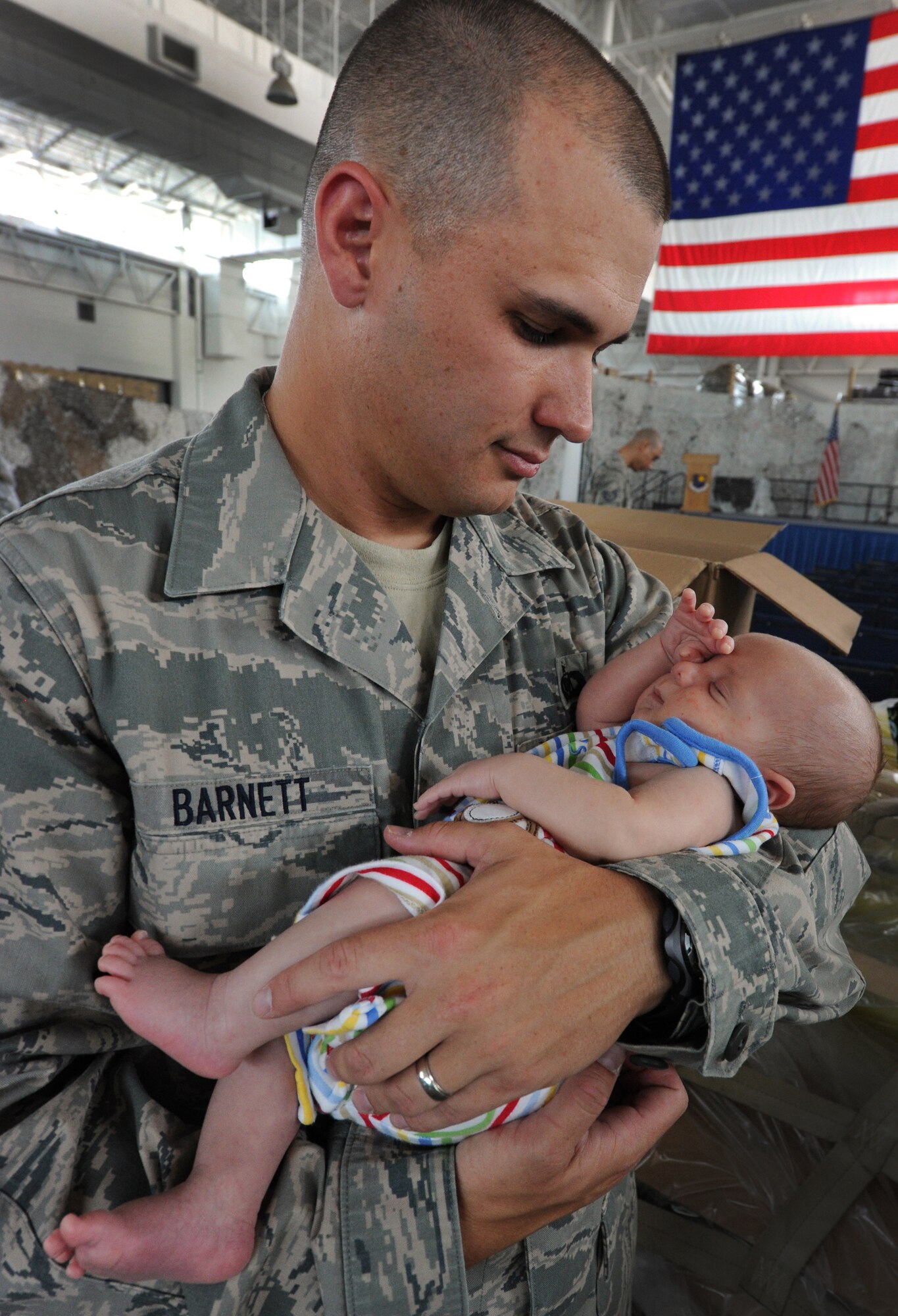 JOINT BASE MCGUIRE-DIX-LAKEHURST, N.J. – Tech. Sgt. Benjamin Barnett, 819th Global Support Squadron airfield operations technician, holds his six-week old boy Benjamin just before deploying with his unit to northern Afghanistan June 2.  Sergeant Barnett and his team were deploying to provide special cargo handling support for the Operation Enduring Freedom logistic surge. (U.S. Air Force photo/Tech. Sgt. Parker Gyokeres/released)