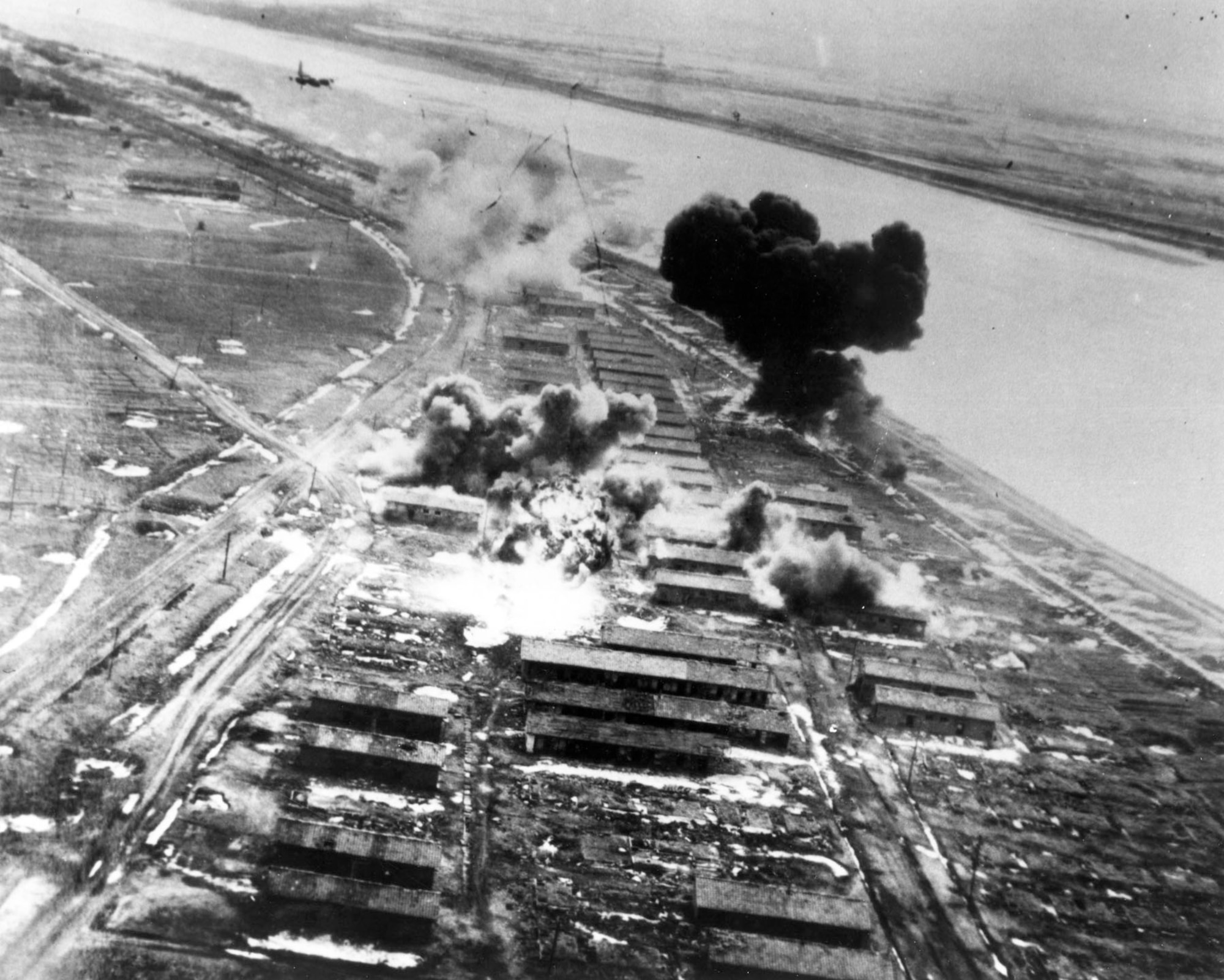 B-26s bomb an enemy storage and barracks area in February 1951. In the upper left corner is a B-26 starting its bomb run. (U.S. Air Force photo)