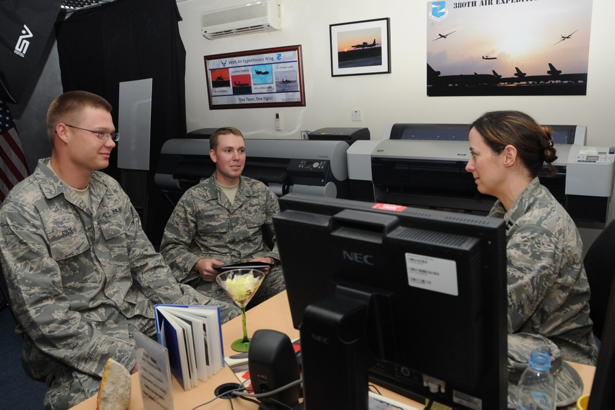 Air Force Academy seniors, Cadet 1st Class Eric Varner (right) and Cadet 1st Class Alan Foote (left), visit the 380th Air Expeditionary Wing Public Affairs Office at an undisclosed location in Southwest Asia as part of their summer deployed operatons program. They deploy to operatoinal wings in the theater to learn about current operations and further develop their leadership abilities. (U.S. Air Force photo/Senior Airman Jenifer H. Calhoun/Released)