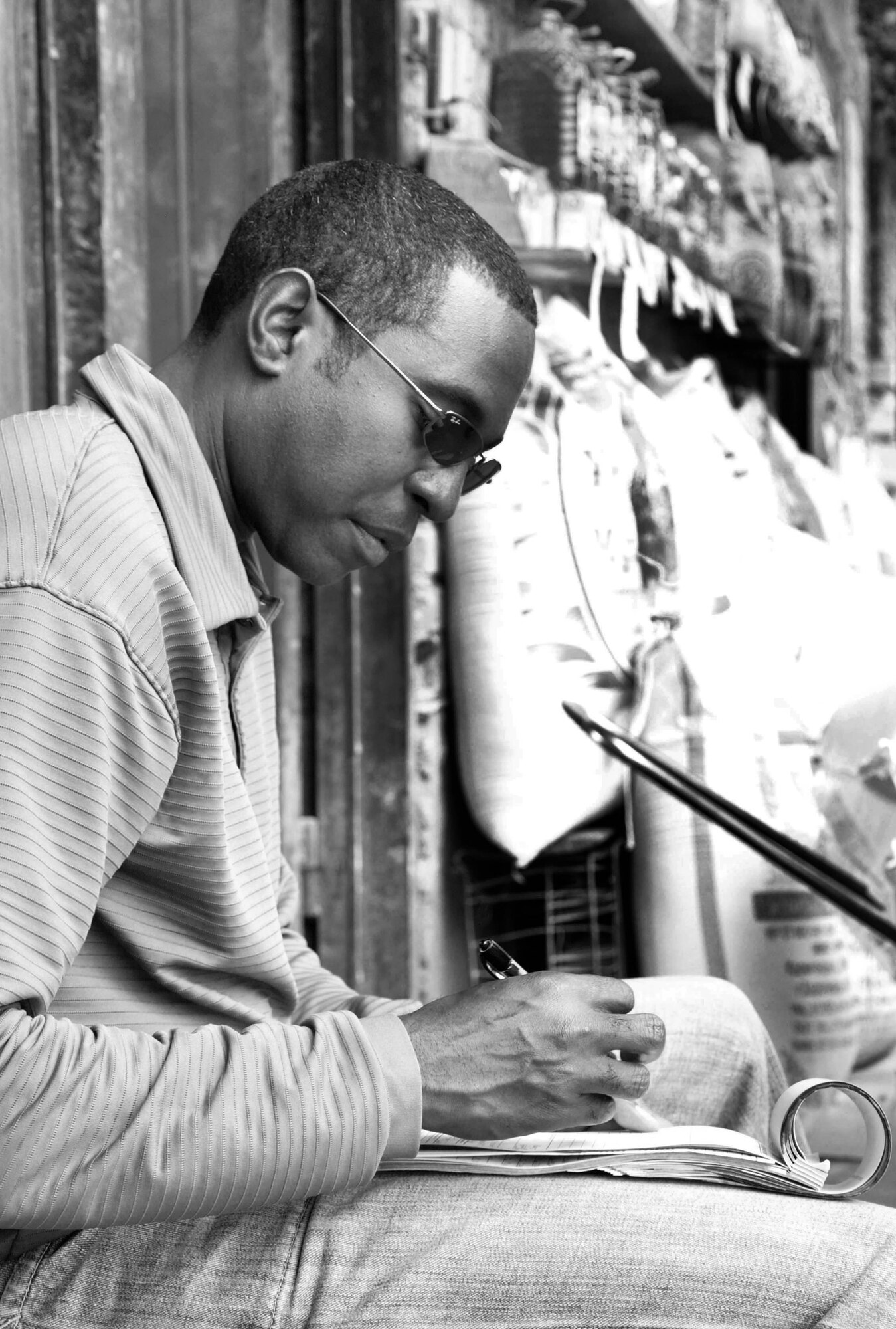 Capt. David Hagler, a contracting officer from the Transit Center at Manas, Kyrgyzstan, adds up totals from a local market from which Airmen purchased flour, pasta, and oil June 7, 2010, for people of Maevka Village who lost all their household goods during the revolution in Kyrgyzstan April 7, 2010. (U.S. Air Force photo/Staff Sgt. Carolyn Viss)
