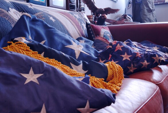 Unserviceable flags line a couch in the office of Master Sgt. Mark DeCorte, 86th Aeromedical Evacuation Squadron aeromedical evacuation technician, June 8, 2010, Ramstein Air Base, Germany. The collection of flags will be honorably retired in a ceremony on base June 14, 2010, at 4 p.m. on the southeast corner of the Commissary parking lot. (U.S. Air Force photo by Senior Airman Amanda Dick)