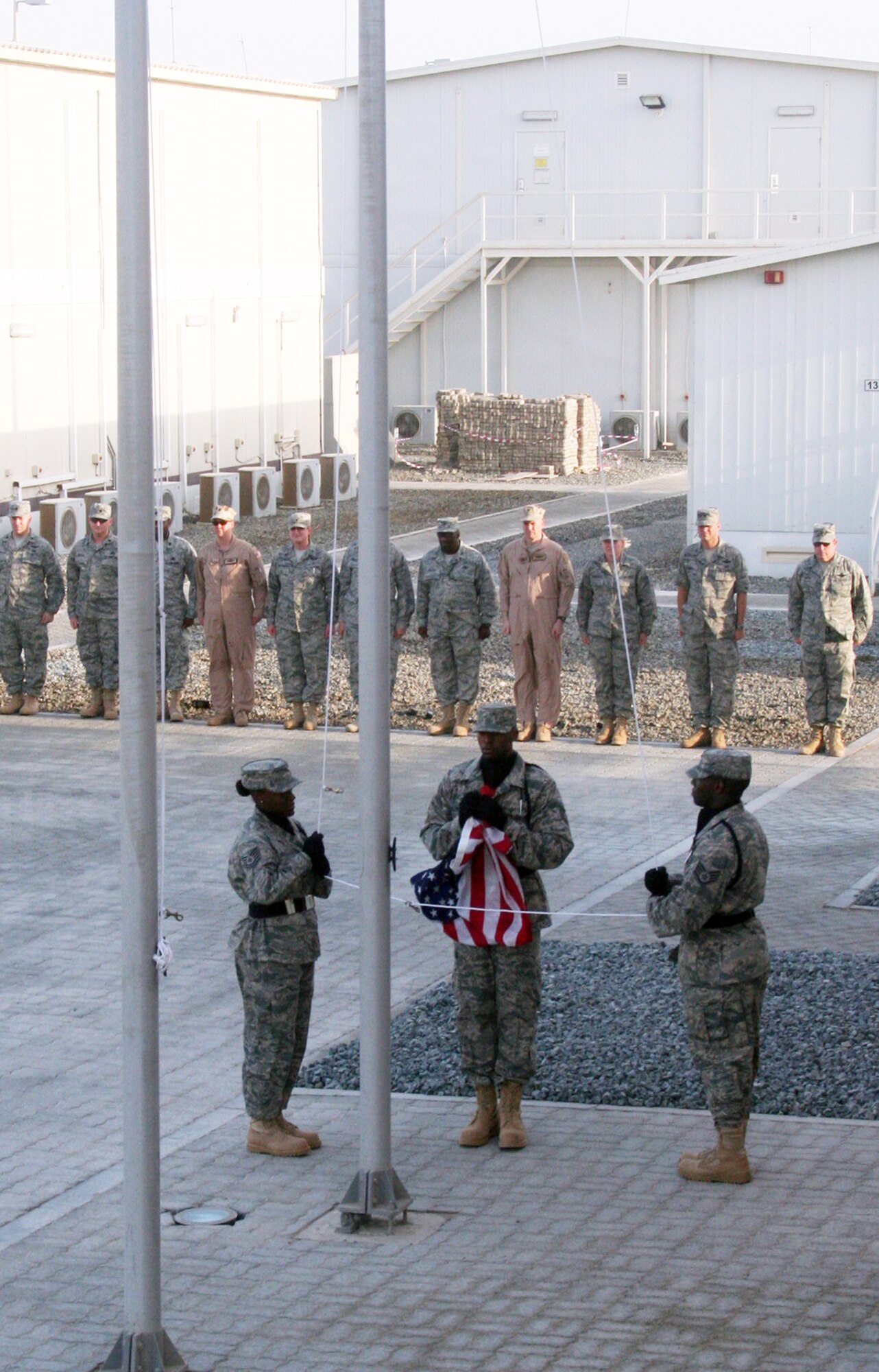 Airmen from the 380th Air Expeditionary Wing participate in a wing retreat ceremony on May 28, 2010, at a non-disclosed base in Southwest Asia. Every week the 380th AEW holds a retreat ceremony honoring the American flag as part of a continuing military tradition. On May 28, the 380th Expeditionary Medical Group served as the lead unit for the retreat. The 380th AEW supports operations Iraqi Freedom and Enduring Freedom and the Combined Joint Task Force-Horn of Africa. (U.S. Air Force Photo/Master Sgt. Scott T. Sturkol/Released)