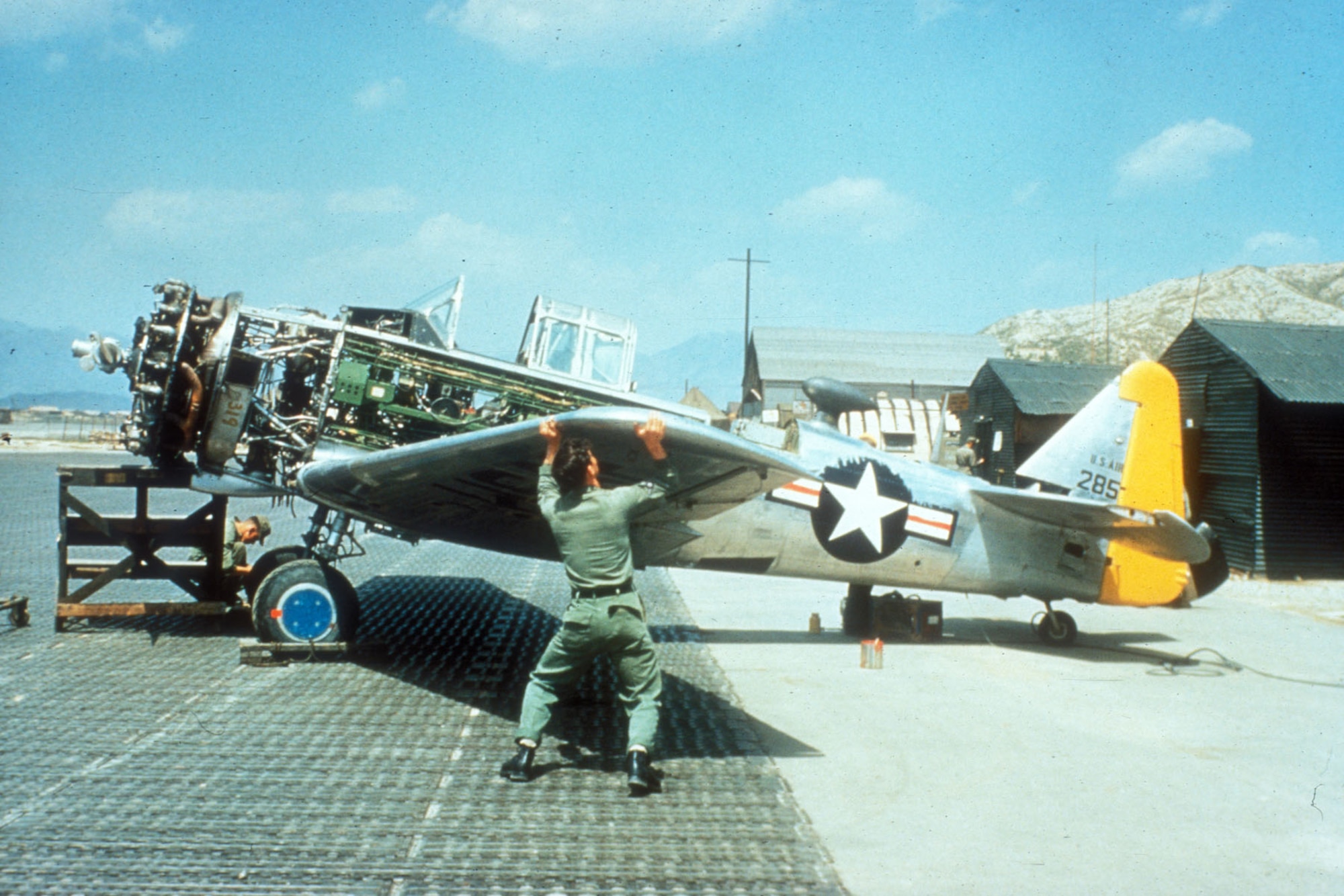 Ground crews performed maintenance in crude field conditions. (U.S. Air Force photo)