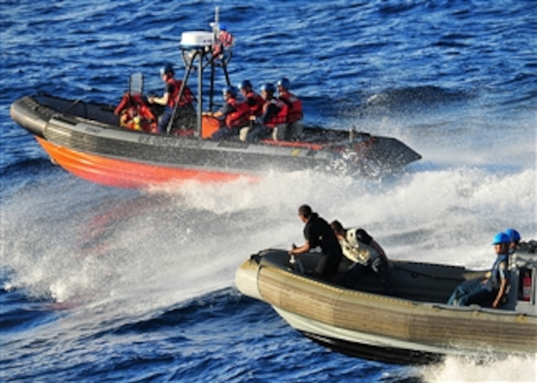 U.S. Coast Guardsmen from USCGC Cutter Mellon (WHEC 717), sailors from USS Vandegrift (FFG 48) and Indonesian sailors conduct combined operations aboard rigid-hulled inflatable boats in the Java Sea on May 30, 2010.  The service members are participating in Naval Engagement Activity Indonesia 2010.  In its 16th year, Naval Engagement Activity is part of the Cooperation Afloat Readiness and Training series of bilateral exercises held annually in Southeast Asia to strengthen relationships and enhance force readiness.  