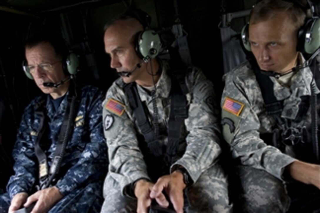 Chairman of the Joint Chiefs of Staff Adm. Mike Mullen is briefed by U.S. Army Col. Terry Sellers and Command Sgt. Maj. Chris Hardy during an aerial tour of Fort Benning, Ga., on June 4, 2010.  