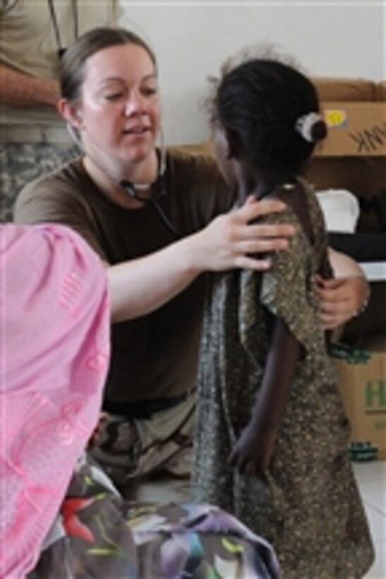 U.S. Navy Lt. j.g. Julie Cole, a physician’s assistant deployed to Combined Joint Task Force Horn of Africa, examines a child during a medical civic action program mission in Tadjourah, Djibouti, on June 2, 2010.  