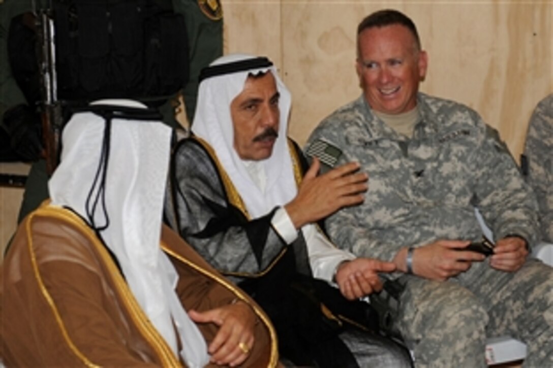 U.S. Army Col. Larry Swift talks with local sheiks on Patrol Base Doria near Kirkuk, Iraq, June 4. 2010. U.S. soldiers assigned to the 1st Armored Division's, 6th Squadron, 1st Armored Cavalry Regiment, 1st Brigade turned over the base to Iraqi Security Forces as part of a phased withdrawal from the region. Swift is the 1st Brigade's commander.