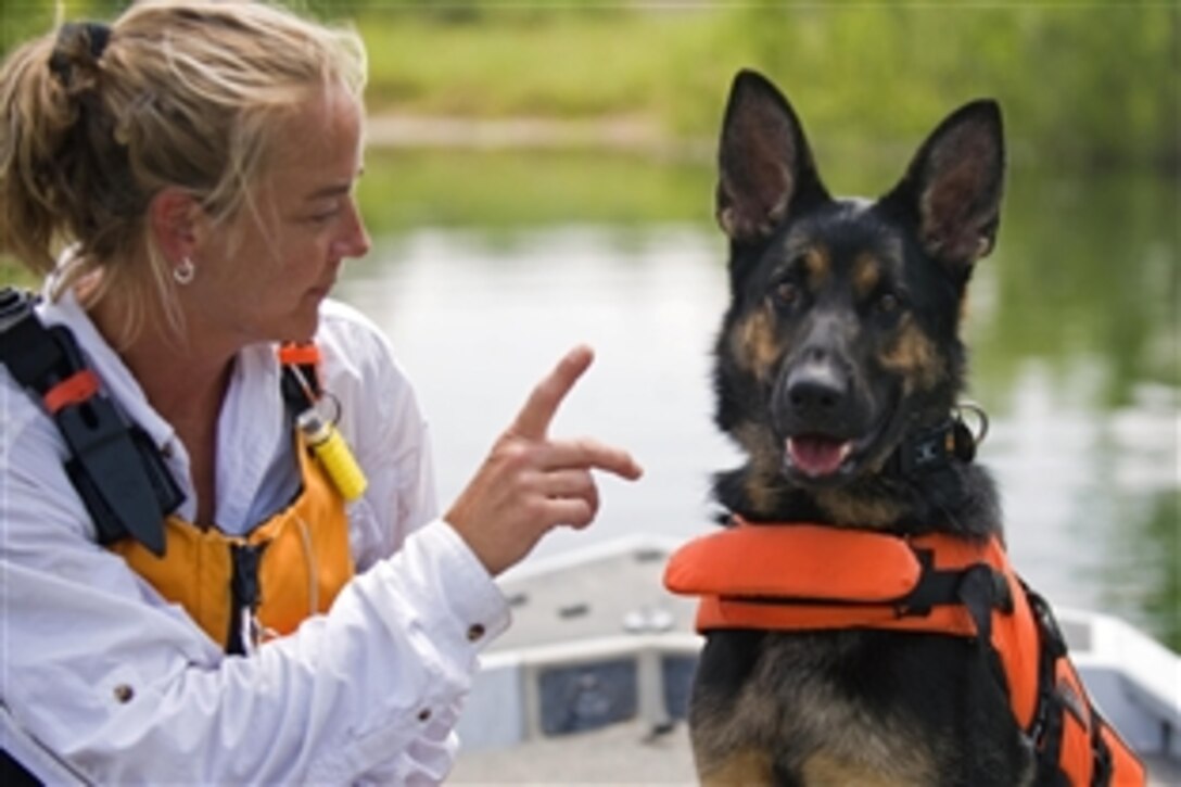 Denice Wethington of New Castle, Ind., gives Brea, her German shepherd search and rescue dog, commands during a training exercise conducted at the Department of Homeland Security Search and Rescue Conference held at the Camp Atterbury Joint Maneuver Training Center, Ind., June 4, 2010. 