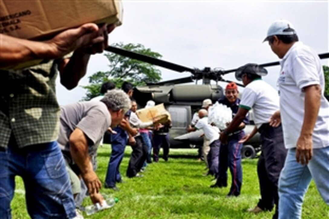 Residents of Masagua, Guatemala, offload food and water from a Joint Task Force-Bravo UH-60 Blackhawk helicopter in Guatemala City, Guatemala, June 3, 2010. Joint Task Force-Bravo deployed four helicopters, at the request of the Guatemalan government, to support disaster relief efforts following the Pacaya Volcano eruption and Tropical Storm Agatha. Members of the task force have helped transport more than 40,000 pounds of relief supplies to six Guatemalan communities.