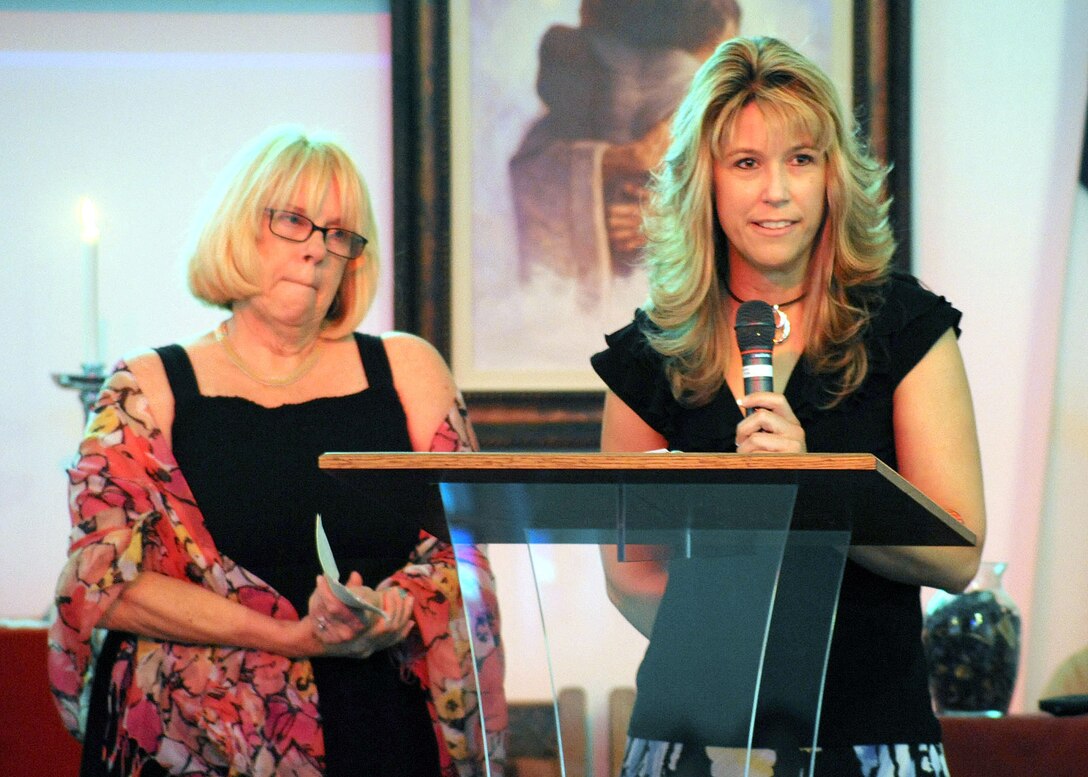 Lieutenant Colonel Robert Lindsley's daughter, Nikki Wattier (right), talks about her father's many attritbutes, one being his love of the Corps, during a memorial service held in his honor June 9. Lindsley's niece, Neila Samuel waits her turn to give her eulogy of the man who treated her like a daughter.