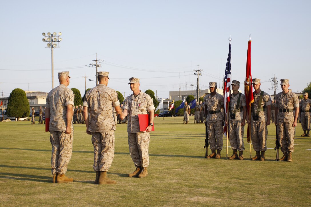 Maj. Edward Seifert, Marine Aviation Logistics Squadron 12 aircraft maintenance officer, shakes hands with Lt. Col. Jonathan Gackle, commanding officer of MALS-12, during Seifert’s retirement ceremony at the parade deck June 14. Seifert reported to MALS-12 at Marine Corps Air Station Iwakuni, Japan, as a warrant officer in 1997 to become the Airframes Division and Aviation Life Support Equipment Division officer-in-charge. After serving in numerous deployments including a 13-month combat tour as the MALS-29 production control officer in support of Operation Iraqi Freedom, Seifert detached from MALS-29 on May 15, 2008 and reported to MALS-12 on June 18, 2008. Seifert was promoted to major on Oct. 1, 2008, and finished out his career as the MALS-12 aircraft maintenance officer.