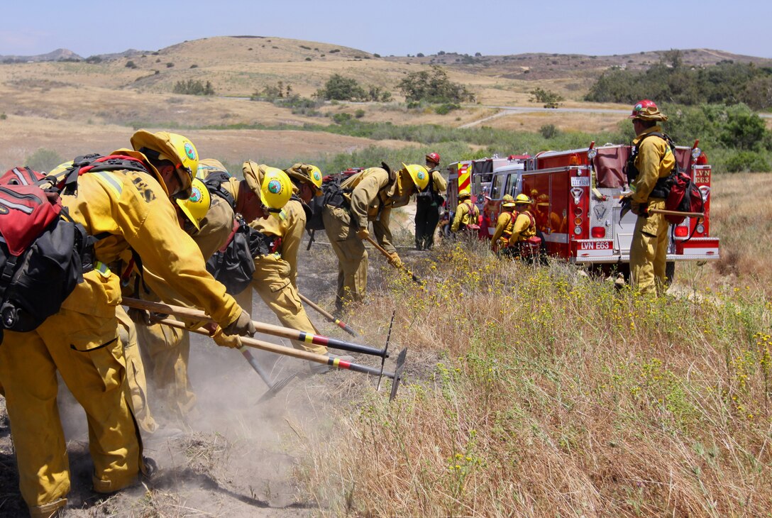 Firemen with Crew 9-2, Los Angeles Fire Department, sections off a burn zone during Camp Pendleton’s 30th annual Fire School training exercise, June 9. In order to remain ready for the fast approaching fire season, more than 350 Southern California firefighters from 50 agencies participated in the training that gave firefighters a chance to practice teamwork by extinguishing fires in a controlled environment.