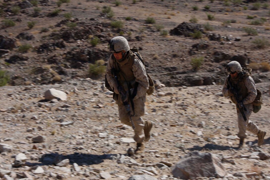 Marines with Company D, 3rd Light Armored Reconnaissance Battalion rush forward to take over a trench June 10 at Combat Center Range 410. The Marines are dismounted scouts with the company. (Photo by: Lance Cpl. M. C. Nerl)