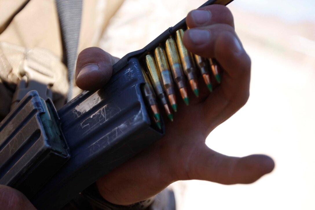 Lance Cpl. Robert Edwards, a mortarman with Company D, 3rd Light Armored Reconnaissance Battalion, loads rounds in preparation for live fire training at Combat Center Ragne 410 June 10. Edwards also fired off a SMAW during the evolution. ::r::::n::