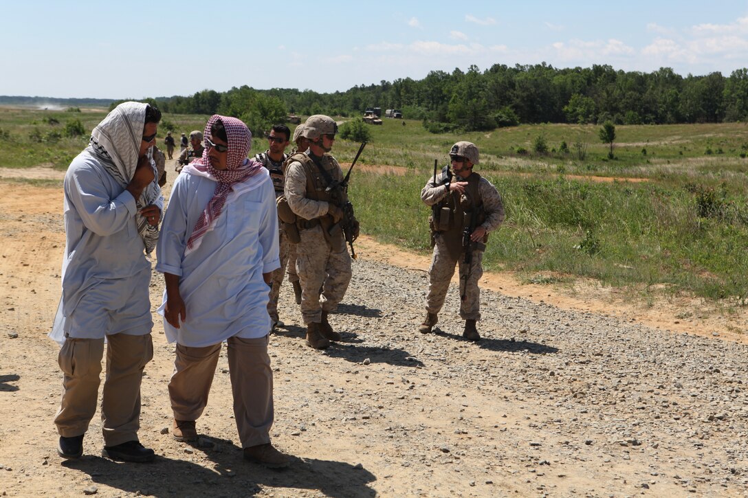 Marines with 1st Platoon, Company K, Battalion Landing Team 3/8, 26th Marine Expeditionary Unit, follow role-players into a village during cultural awareness training as part of Realistic Urban Training at Fort A.P Hill, Va., June 10, 2010. The Marines came to the village to meet with community elders and find out what needs the community had. This was just one of many courses conducted during the 18-day Realistic Urban Training Exercises the MEU will participate in as part of its pre-deployment training. The urban environment is among the most challenging tactical environments MEU Marines may face during their scheduled deployment later this fall.