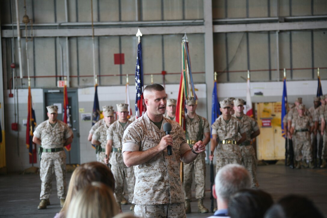Lt. Col. Kirk Nothelfer, new commanding officer for Marine Tactical Electronic Warfare Squadron 3, speaks to friends and families of VMAQ-3 Marines during the change of command ceremony, June 10.