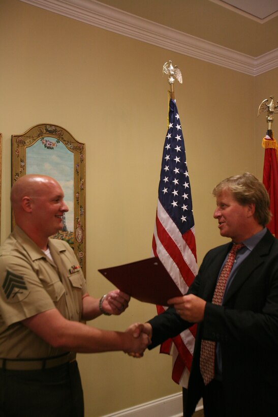 (Right) The Mayor of New Bern, Lee Wilson Bettis Jr., presents Sgt. Joshua L. Hauley, the electric shop for Marine Aerial Refueler Transport Squadron 252, a certificate of commendation at the New Bern Golf and Country Club June 10.::r::::n::“You can stand by and hope somebody else does it, or you can get out there and do it yourself,” said Hauley.::r::::n::