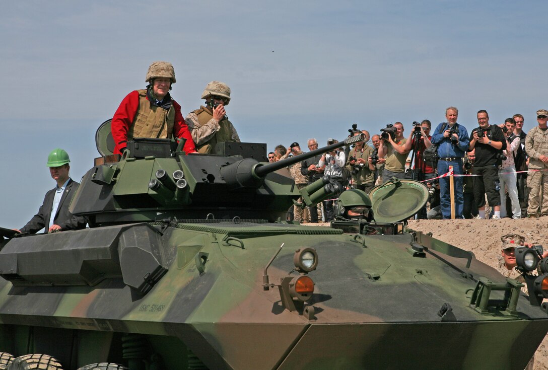 Latvian President Valdis Zatlers (in red on top of vehicle) rides a Light Armored Reconnaissance Vehicle through the beach entry access point constructed to aid maritime preposition force offload exercises and increase access to local recreation areas here. President Zatlers visited the Marines and Sailors of 4th Landing Support Battalion and Naval Beach Group 2, who have been working together with Latvian forces to conduct maritime preposition force offload operations and other training events here since the start of the exercise June 6.