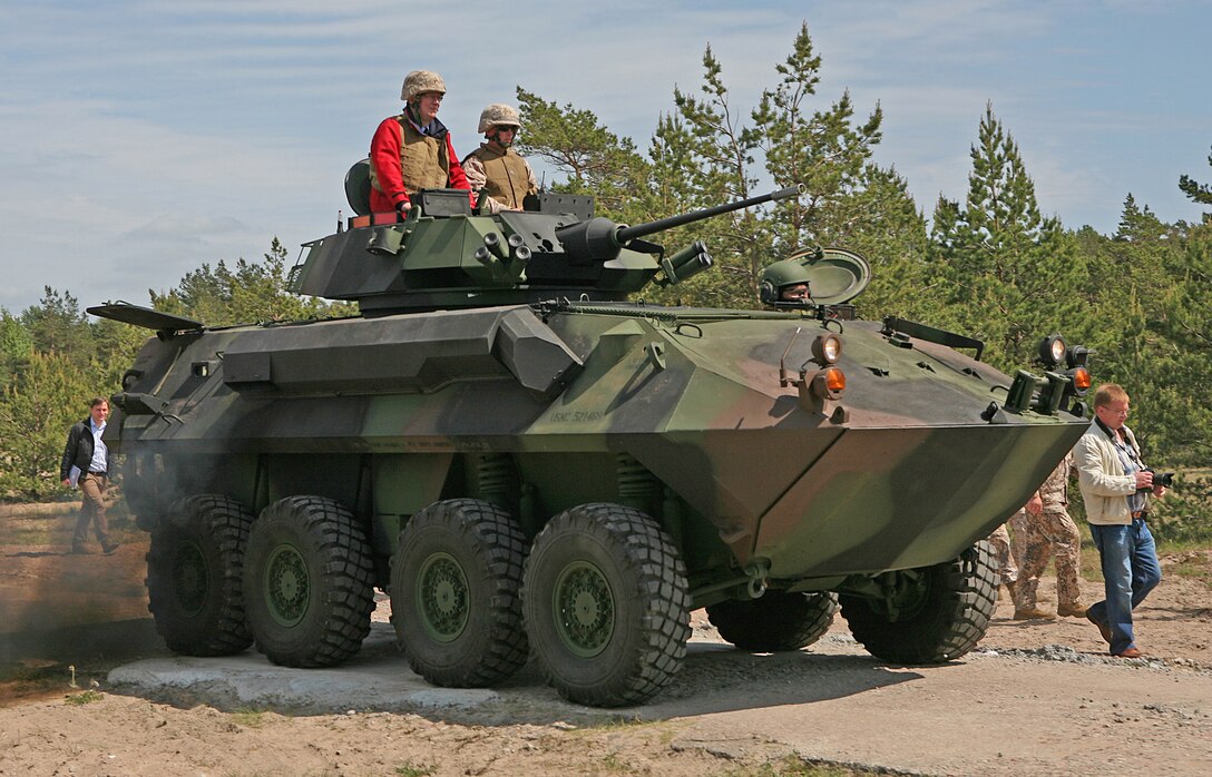 Latvian President Valdis Zatlers (in red on top of vehicle) rides a Light Armored Reconnaissance Vehicle that had moved ashore after being offloaded the USNS Pfc. Eugene A. Obregon, a maritime preposition force (MPF) ship, during a demonstration designed to highlight the types of training that have taken place during exercise Baltic Operations 2010. President Zatlers visited the Marines and Sailors of 4th Landing Support Battalion and Naval Beach Group 2, who have been working together with Latvian forces to conduct MPF offload operations and other training events here since the start of the exercise June 6.