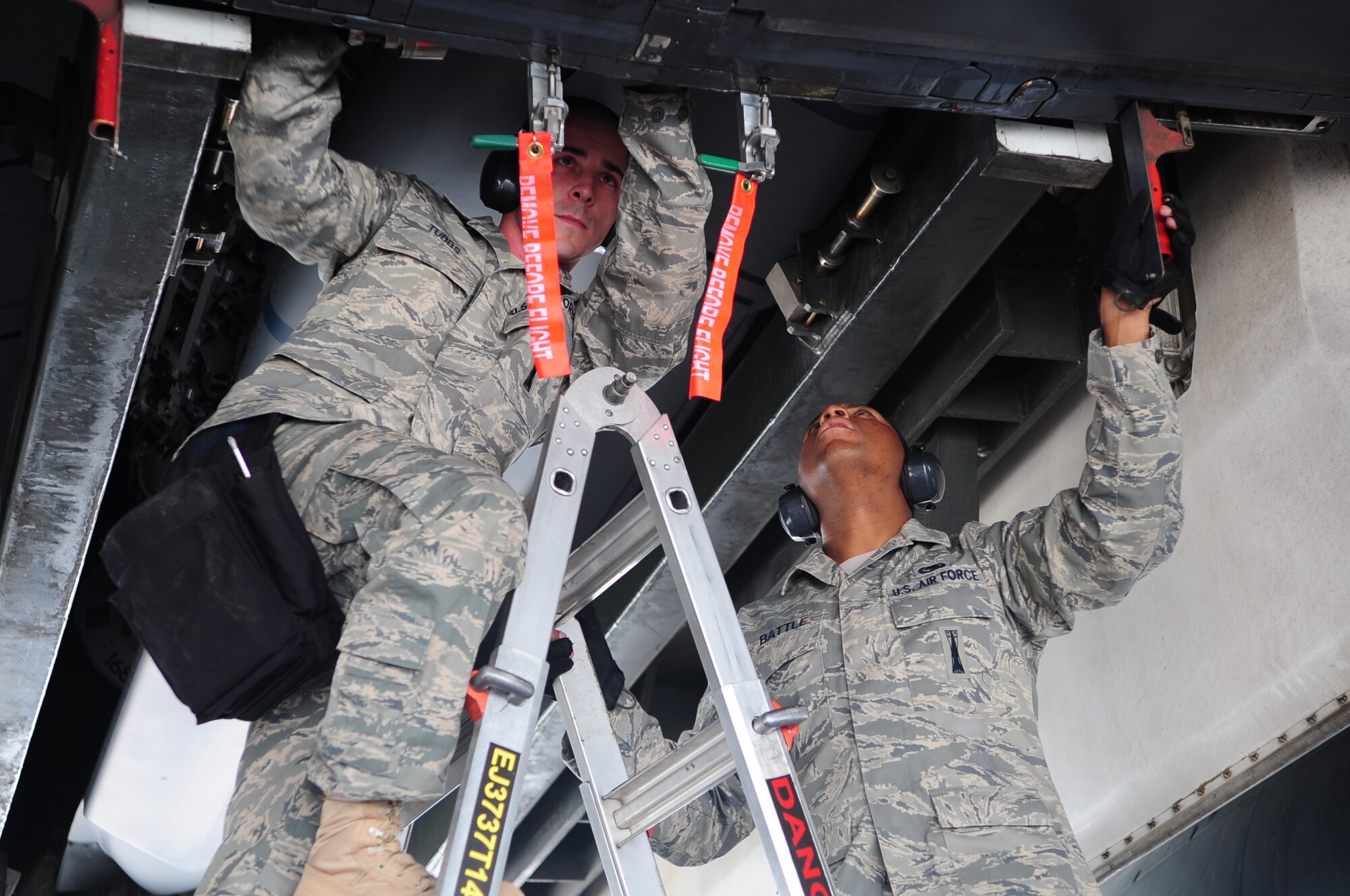 ELLSWORTH AIR FORCE BASE S.D. -  (Left) Tech. Sergeant Taft Tubbs and Senior Airman Tavares Battle, 28th Aircraft Maintenance Squadron load crew members, perform a weapons load during the Global Strike Challenge, June 9. The Global Strike Challenge consists of a uniform inspection, general knowledge test, tool inspection, munitions build, weapons load and B-1B Lancer pre-flight inspection. (U.S. Air Force photo/Airman 1st Class Corey Hook)