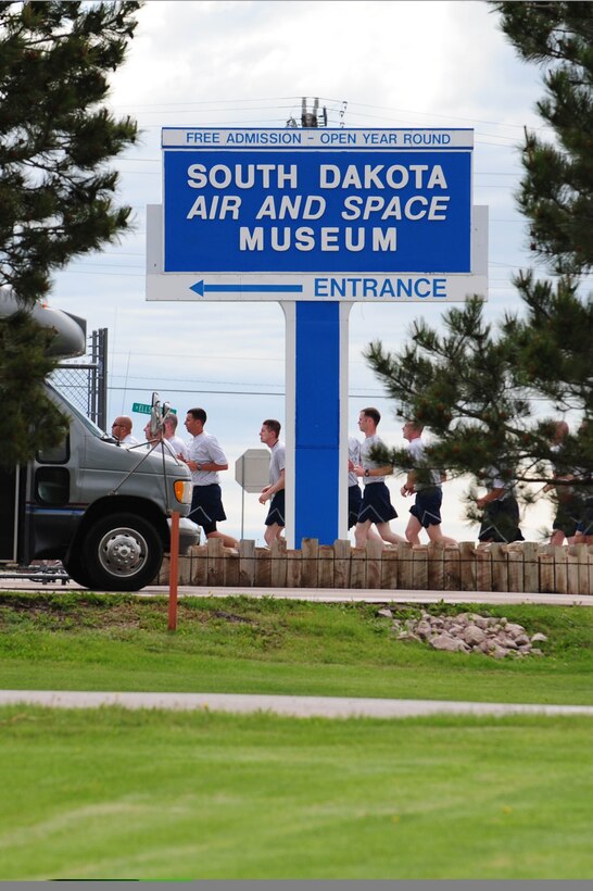 Members of the 28th Munitions Squadron run from the Civil Engineer football field to the South Dakota Air and Space Museum to clean a B-29 Superfortress static display, June 4. Along with the 28th Munitions Squadron, other squadrons from the 28th Bomb Wing maintain an “adopted plane.”  (U.S. Air Force photo/Airman 1st Class Corey Hook)