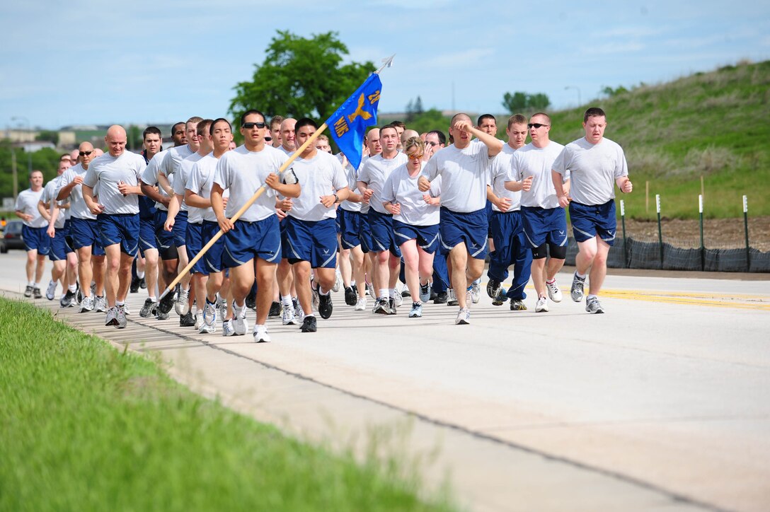 ELLSWORTH AIR FORCE BASE S.D. -- Members of the 28th Munitions Squadron run from the Civil Engineer football field to the South Dakota Air and Space Museum to clean a B-29 Superfortress static display, June 4.  The run to the museum performed by the 28th Munitions Squadron members is approximately two miles. (U.S. Air Force photo/Airman 1st Class Corey Hook)
