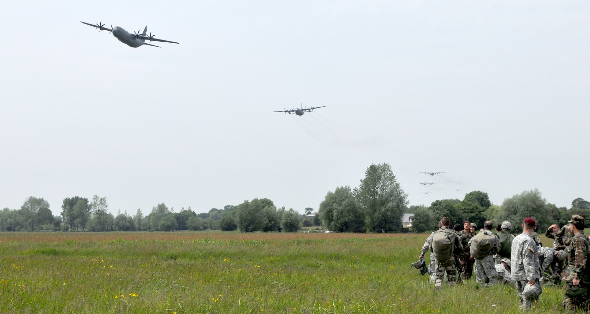 A C-130J Super Hercules leads a formation June 5, 2010 of other American C-130s and German and French C-160s above the drop zone where Allies landed during World War II in Normandy, France. The aircraft is from the 37th Airlift Squadron at Ramstein Air Base, Germany.  (U.S. Air Force photo/Staff Sgt. Austin M. May)