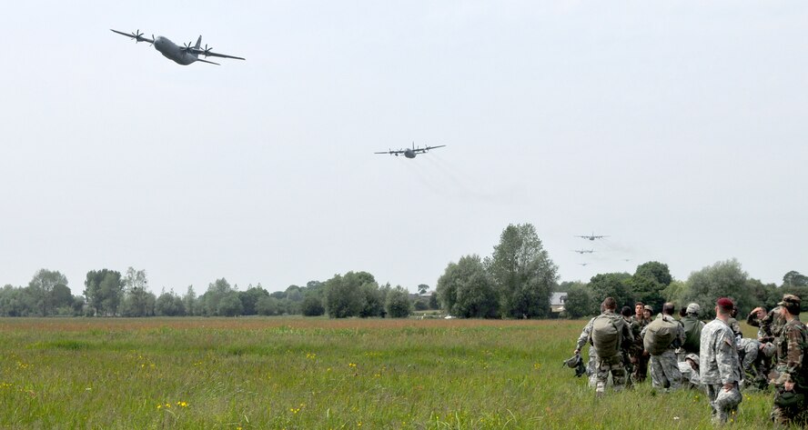 A C-130J Super Hercules leads a formation June 5, 2010, of other American C-130s and German and French C-160s above the drop zone where Allies landed during World War II in Normandy, France. The aircraft is from the 37th Airlift Squadron at Ramstein Air Base, Germany. (U.S. Air Force photo/Staff Sgt. Austin M. May) 

