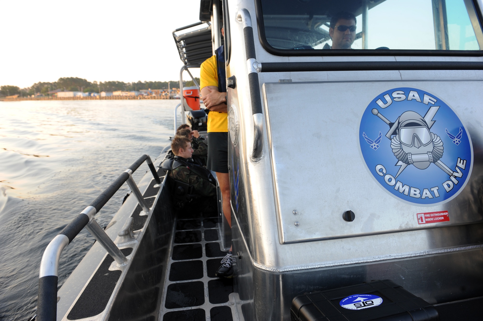 Airmen sit in a boat as they wait to be transported back to their unit after completing an early morning dive during their combat dive course June 10, 2010, at Panama City Beach, Fla. The Airmen are combat controllers-in-training assigned to the 342nd Training Squadron Det. 2. (U.S. Air Force photo/Staff Sgt. Desiree N. Palacios) 