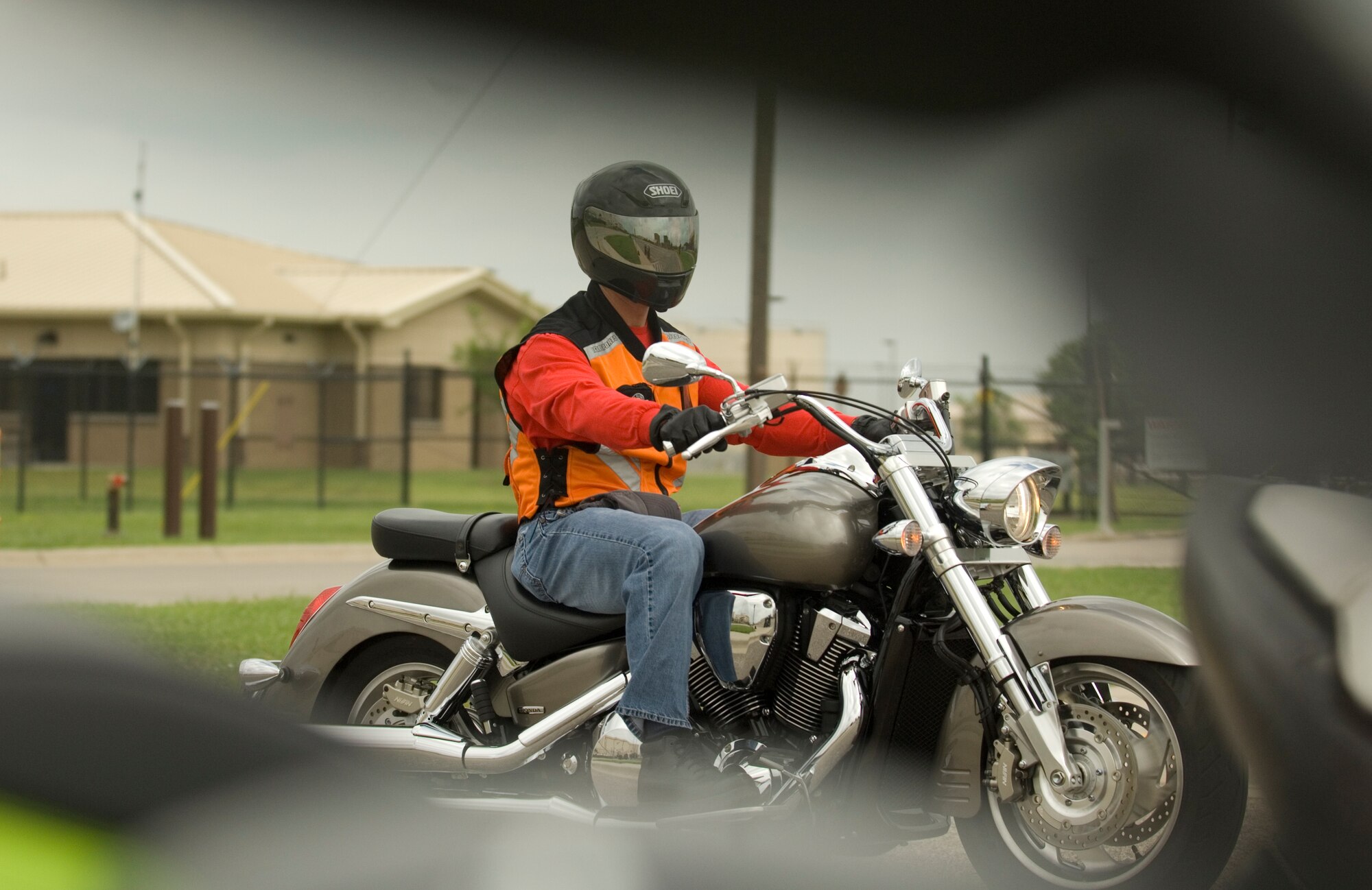 Master Sgt. Dan Ayres, 184th Intelligence Wing recruiting office supervisor, rides into the motorcycle training range to instruct the Beginner Rider Course June 10, 2010. Motorcycle safety is an integral part of the Air Force’s Critical Days of Summer program. McConnell offers its more than 245 riders three classes, depending on their level of expertise. (U.S. Air Force photo/Airman Armando A. Schwier-Morales)
