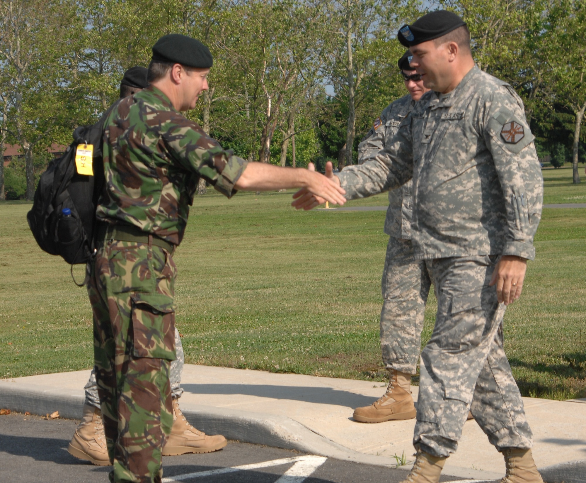 Maj. Gen. Greg Smith, U.K. Defence Staff for Reserves and Cadets assistant chief, greets Col. Patrick Slowey, Army Support Activity–Dix commander. Reserve military leaders from the United Kingdom visited Joint Base McGuire-Dix-Lakehurst to witness ASA’s transformation from a strategic reserve to an operational force June 2. (U.S. Army photo/David Moore)