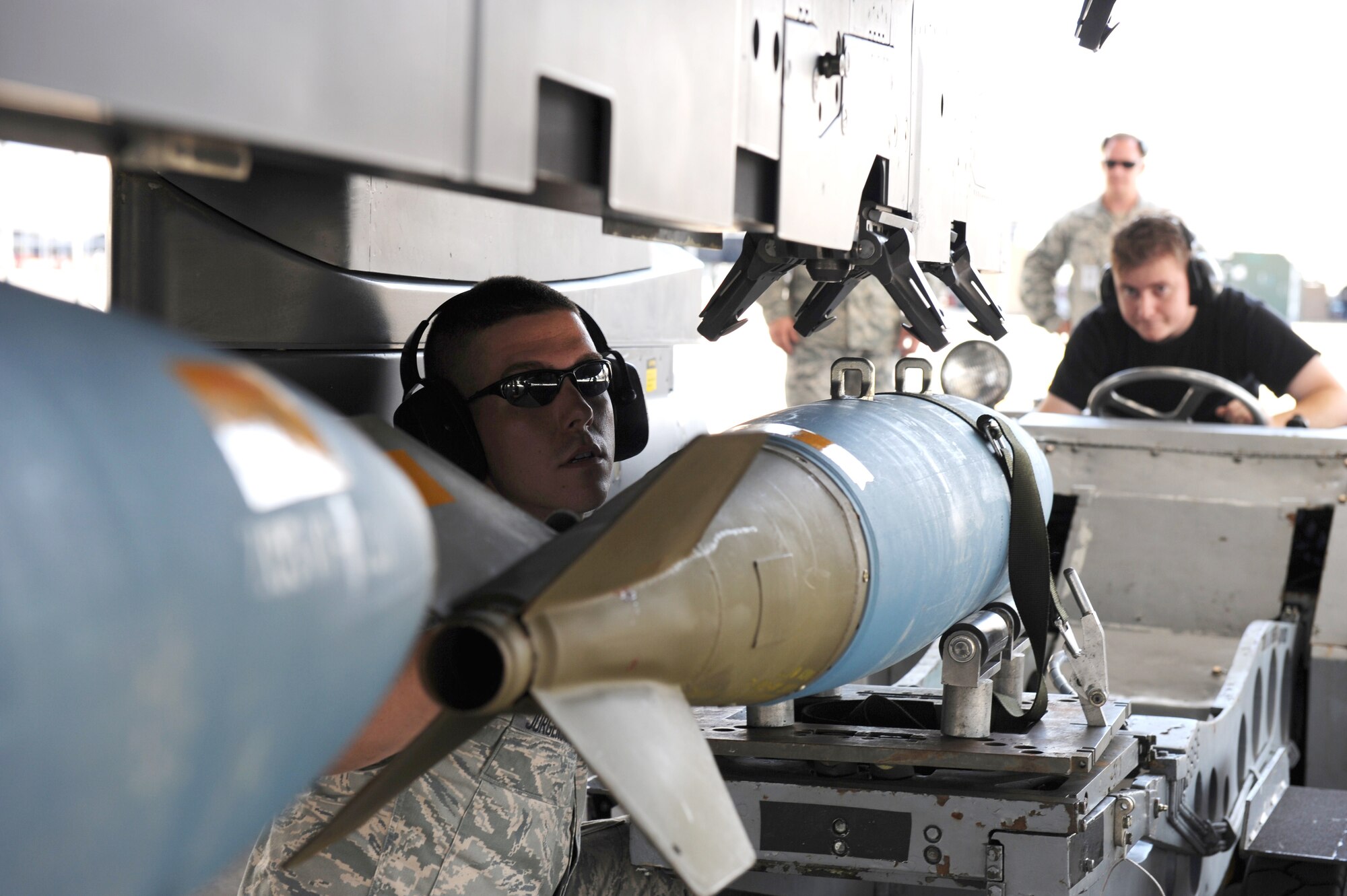 SEYMOUR JOHNSON AIR FORCE BASE, N.C. -- Senior Airman John Klinedinst uses a MJ-1B "Jammer" to position a BDU-50 munition into place for Senior Airman Cody Jurgensmeyer as part of a Phase I Operational Readiness Exercise here June 8, 2010. Weapons loading requires a high level of situational awareness, precise communication between team members and a steady hand on the hydraulic controls used to accurately position munitions. Airman Klinedinst, load crew member, is from Phoenix and Airman Jurgensmeyer, load crew  team chief, hails from Lincoln, Calif.  Both Airmen are assigned to the 334th Aircraft Maintenance Unit.  (U.S. Air Force photo/1st Lt. Matt Schroff)