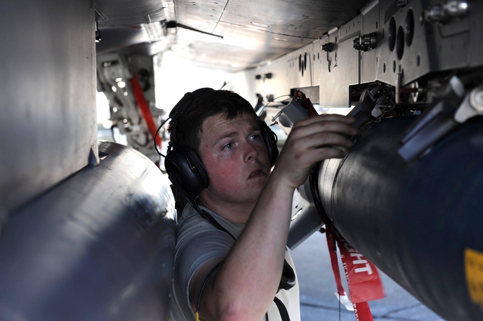 SEYMOUR JOHNSON AIR FORCE BASE, N.C. -- Airman 1st Class Mathew Schmid checks a GBU-12 hanging underneath an F-15E Strike Eagle during a Phase I Operational Readiness Exercise here June 8, 2010. The aircraft, assigned to the 335th Fighter Squadron, was one of more than a dozen that passed the Exercise Evaluation Team's comprehensive inspection with no significant write-ups during the initial phases of the ORE. Airman Schmid, a load crew member assigned to the 334th Aircraft Maintenance Unit, hails from Lincoln, Calif.  (U.S. Air Force photo/1st Lt. Matt Schroff)