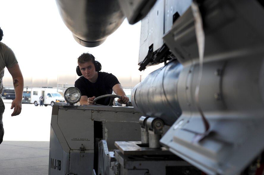 SEYMOUR JOHNSON AIR FORCE BASE, N.C. -- Senior Airman John Klinedinst operates an MJ-1B "Jammer" to ensure proper placement of a GBU-12 beneath an F-15E Strike Eagle during a Phase I Operational Readiness Exercise here June 8, 2010. The Jammer's hydraulic controls allow Airmen to raise a variety of munitions to the proper position for attachment to the underside of an aircraft. Airman Klinedinst, a load crew member from the 334th Aircraft Maintenance Unit, is from Phoenix. (U.S. Air Force photo/1st Lt. Matt Schroff)