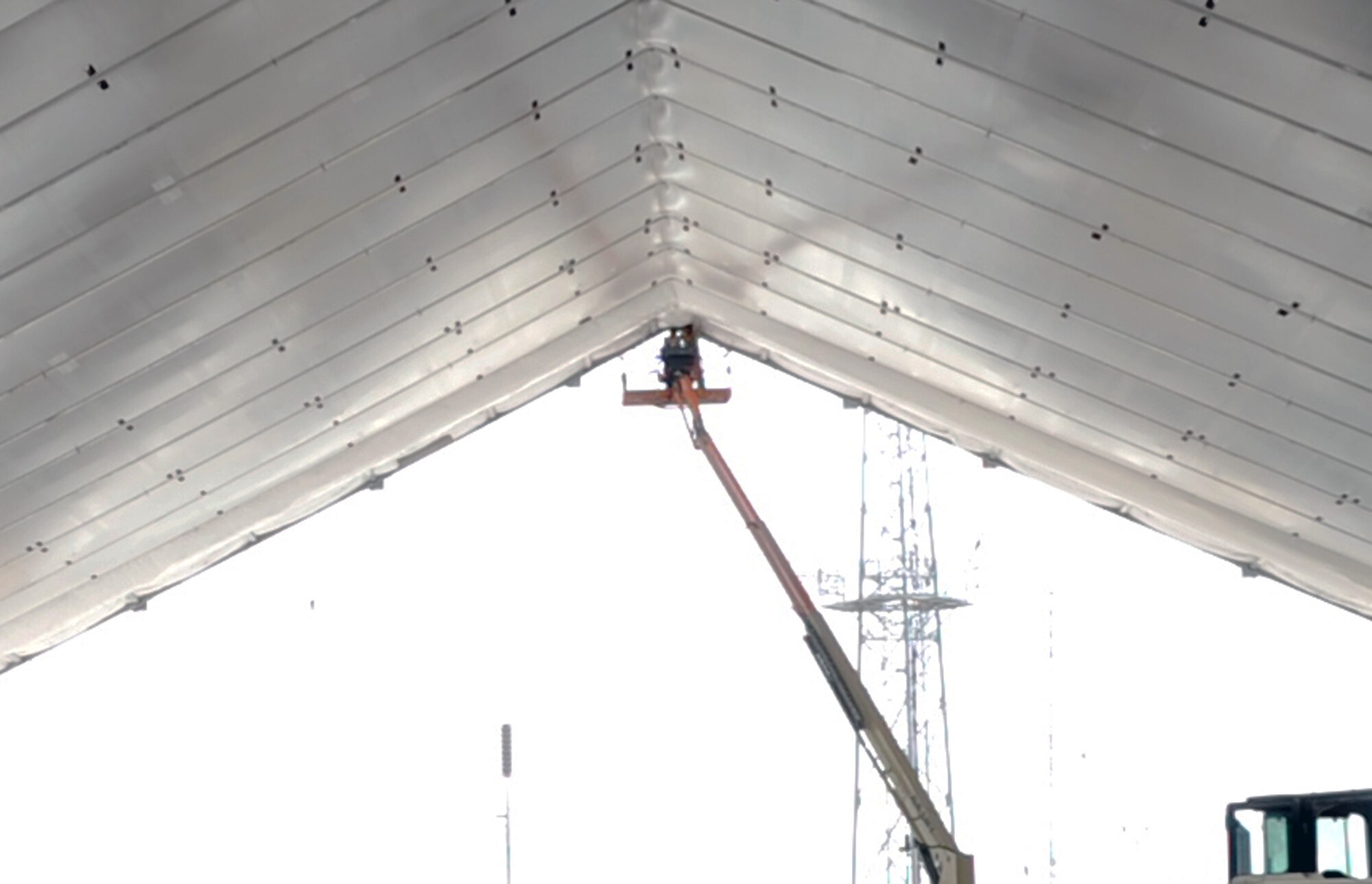 Airmen from the 380th Expeditionary Civil Engineer Squadron work on assembling covering for an expeditionary aircraft hangar during operations for the 380th Air Expeditionary Wing on June 2, 2010, at a non-disclosed base in Southwest Asia. Civil engineering Airmen having been working continuously for more than two months upgrading airfield structures for the 380th AEW. The 380th AEW supports operations Iraqi Freedom and Enduring Freedom and the Combined Joint Task Force-Horn of Africa. (U.S. Air Force Photo/Master Sgt. Scott T. Sturkol/Released)