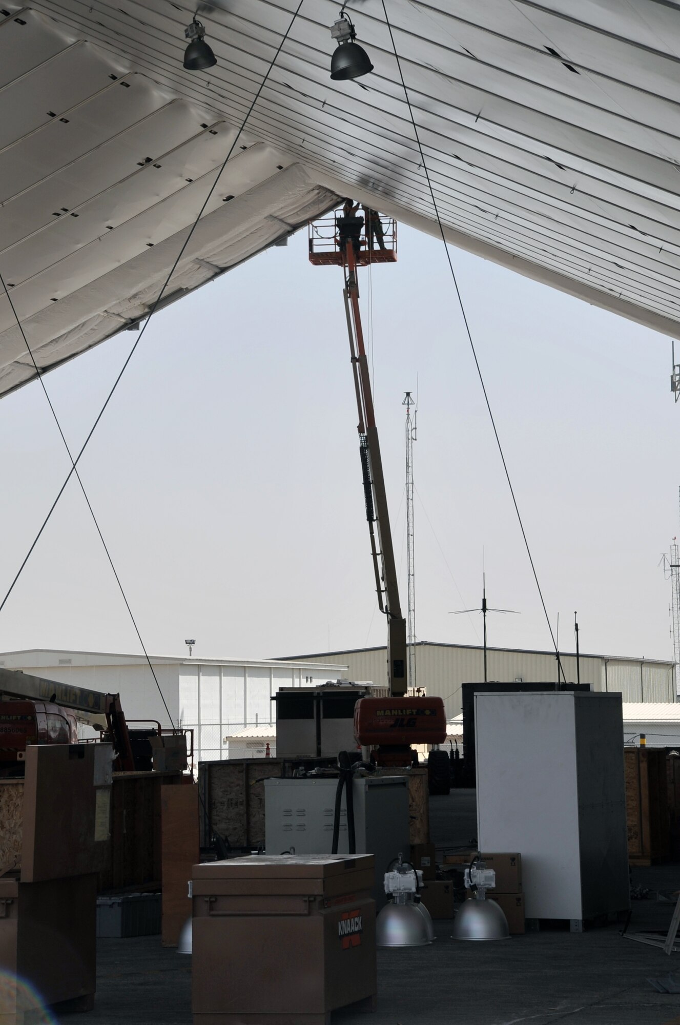 Airmen from the 380th Expeditionary Civil Engineer Squadron work on assembling covering for an expeditionary aircraft hangar during operations for the 380th Air Expeditionary Wing on June 2, 2010, at a non-disclosed base in Southwest Asia. Civil engineering Airmen having been working continuously for more than two months upgrading airfield structures for the 380th AEW. The 380th AEW supports operations Iraqi Freedom and Enduring Freedom and the Combined Joint Task Force-Horn of Africa. (U.S. Air Force Photo/Master Sgt. Scott T. Sturkol/Released)