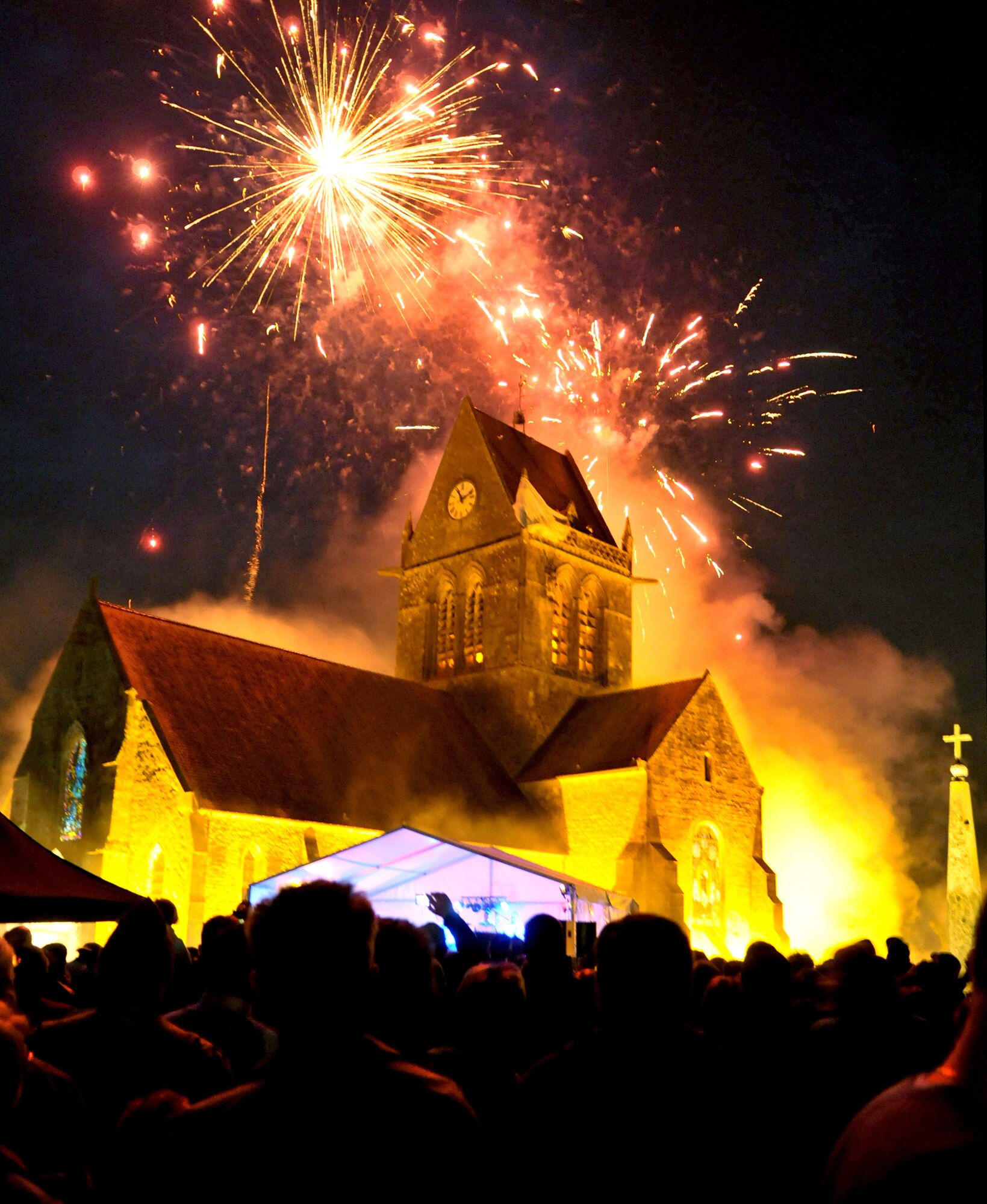 Fireworks burst June 5, 2010, over a church in St. Mere Eglise, France, during a celebration commemorating the 66th anniversary of the D-Day landings in World War II. French, British, German and American servicemembers participated in a memorial parachute drop here. (U.S. Air Force photo/Staff Sgt. Austin M. May)
