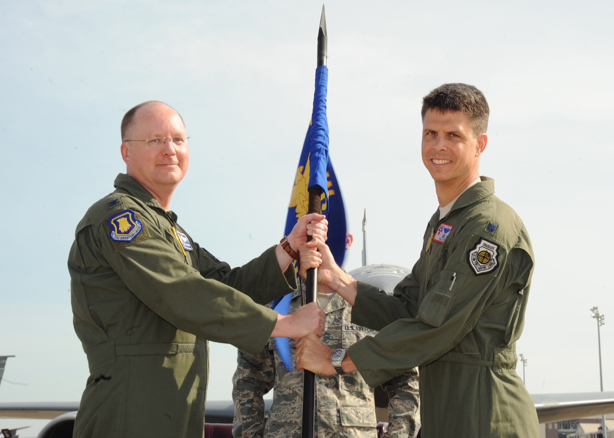 Col. Billy R. Langford, 22nd Operations Group commander, hands the guidon to Lt. Col. Paul J. Scott, 22nd Operations Support Squadron commander, during a change of command ceremony June 4, 2010, McConnell Air Force Base, Kan.  The passing of the guidon symbolizes Colonel Scott assuming command from the outgoing 22nd OSS commander, Lt. Col. Robert Mallets. (U.S. Air Force photo/Senior Airman Maria Ruiz)