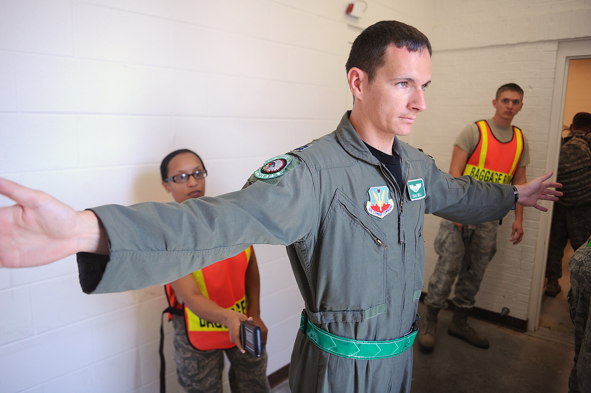 SEYMOUR JOHNSON AIR FORCE BASE, N.C. -- Staff Sgt. Adrianne Gary uses a metal detector to scan Capt. Isaac Bell during a Phase I Operational Readiness Exercise June 8, 2010. Personnel use metal detectors to check for any metal objects, concealed weapons or unauthorized items. Sergeant Gary, 4th Component Maintenance Squadron armament systems technician, hails from Neptune, N.J. Capt. Bell, 335th Fighter Squadron pilot, is from Borden, Ind. (U.S. Air Force photo/Senior Airman Ciara Wymbs)   
