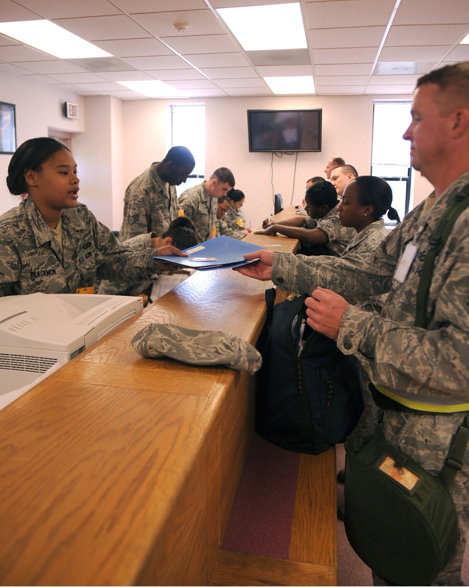 SEYMOUR JOHNSON AIR FORCE BASE, N.C. -- Airmen from the 4th Force Support Squadron Military Personnel Element check mobility records and dog tags during a Phase I Operational Readiness Exercise June 8, 2010. The Airmen review each deployer's records to ensure personnel information and training is current and accurate. (U.S. Air Force photo/Senior Airman Ciara Wymbs) 
