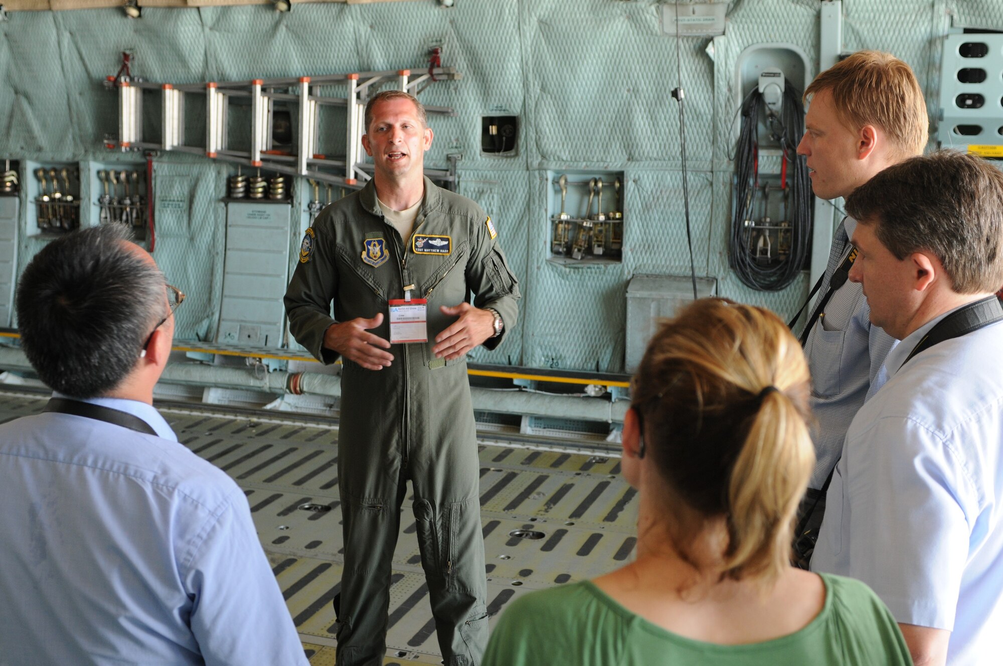 BERLIN -- Tech. Sgt. Matthew Harr, 709th Airlift Squadron loadmaster from Dover Air Force Base, Del., acts as a tour guide to visitors during the ILA 2010 Berlin International Aerospace Exhibition and Conferences at the Berlin-Schoenefeld Airport June 9. During the air show, the visitors are given the opportunity to see various aspects of the aircraft, including the flight and cargo decks, as well as the cockpit. (U.S. Air Force photo/Staff Sgt. Julius Delos Reyes)